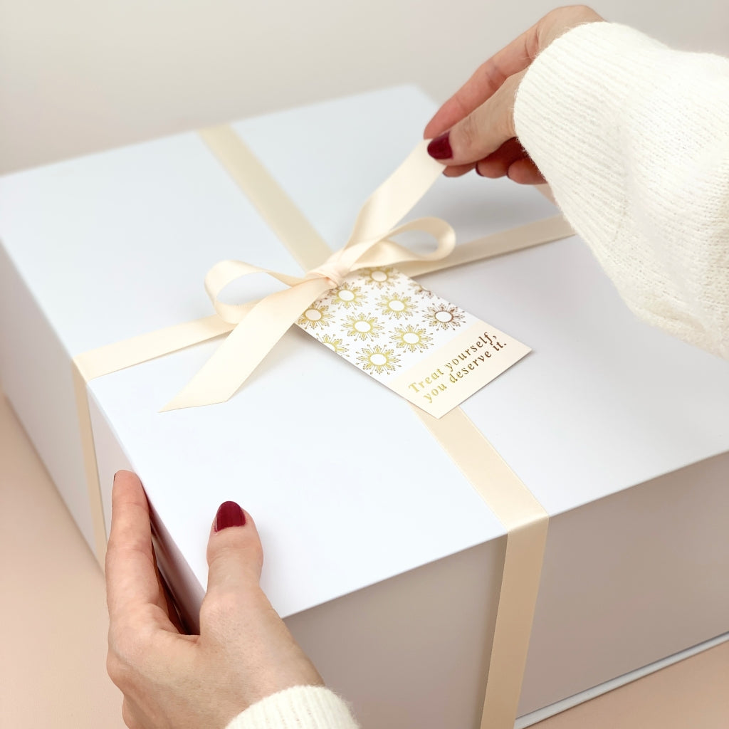 Luxury White Gift Box with Magnetic Closure, Cream Filling, Silk Ribbon and a Gift Tag that reads "Treat yourself, you deserve it."